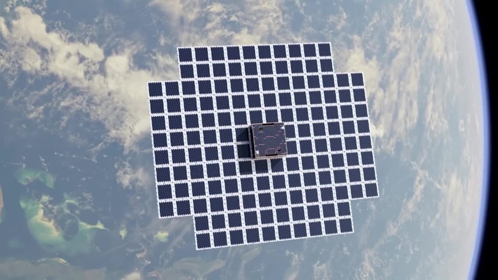 An image of a satellite with a very large solar array as it floats above the Earth